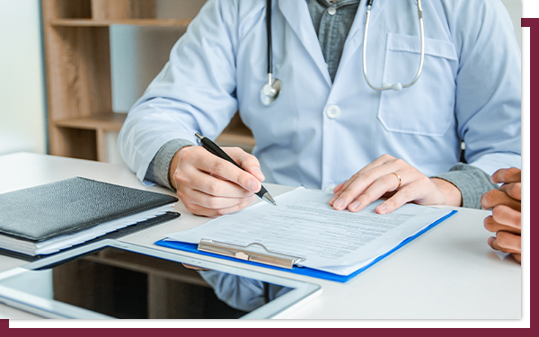 A doctor looking at testing options on a tablet and marking on a sheet.