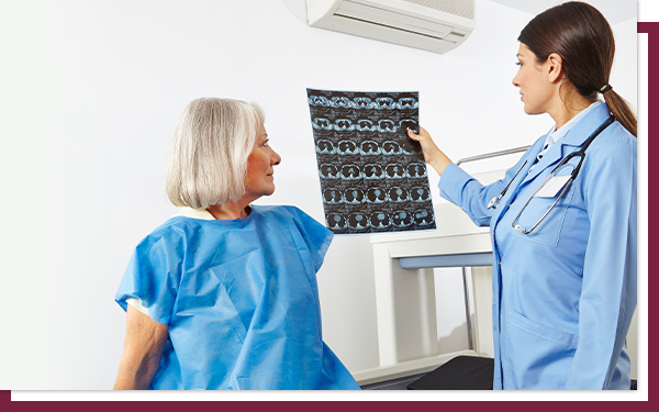 A woman talking to her doctor and looking at images after getting a breast MRI