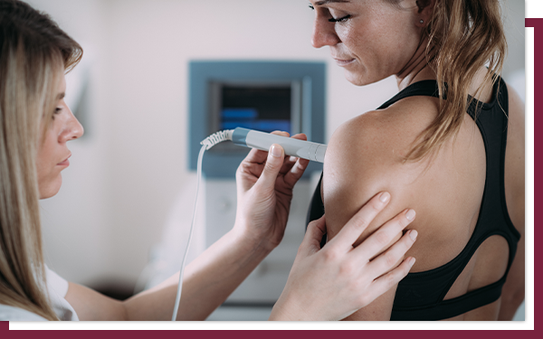 A young woman receives an ultrasound on her breast.