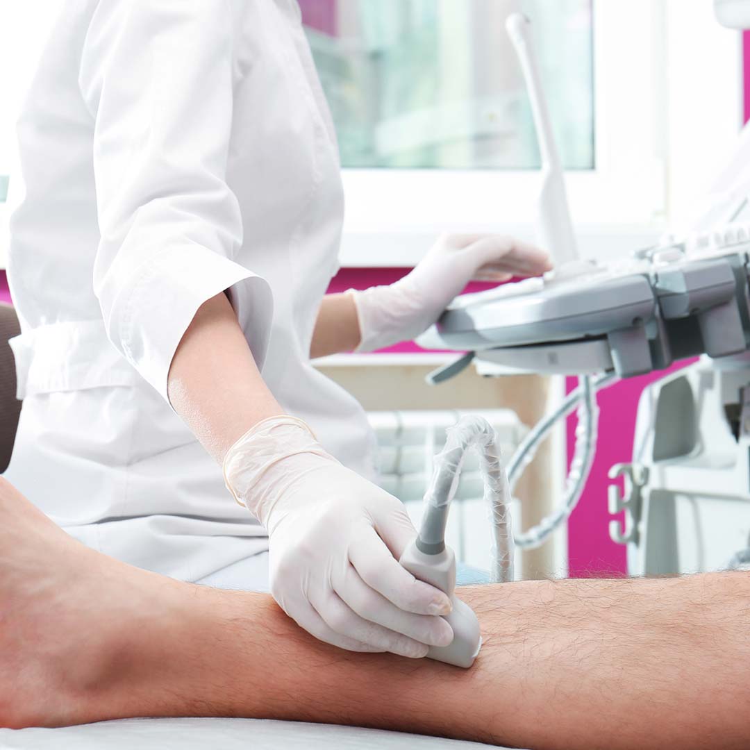 Doctor conducting ultrasound examination of patient`s leg in clinic