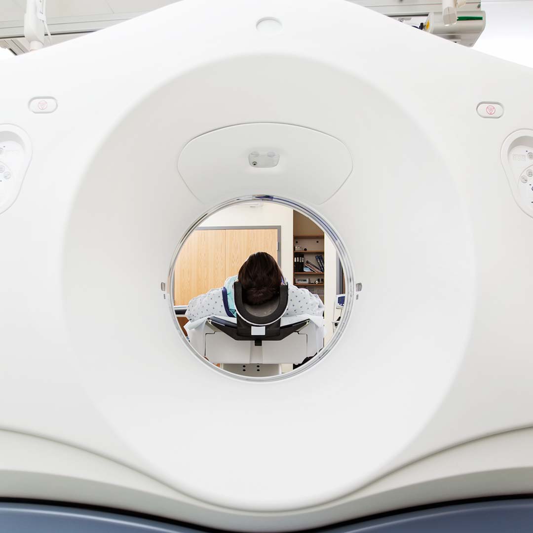 Female patient undergoing CT scan test in examination room