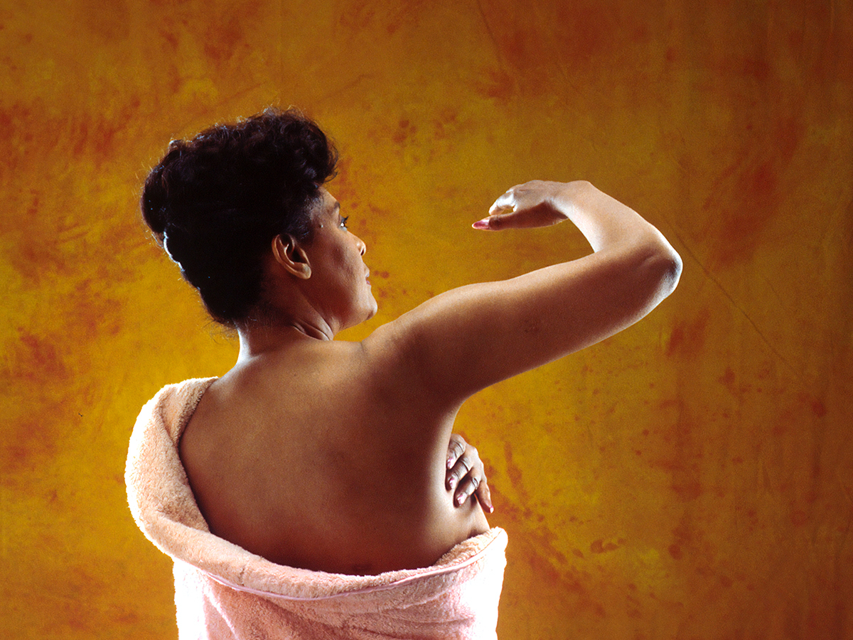 woman doing a breast exam on herself