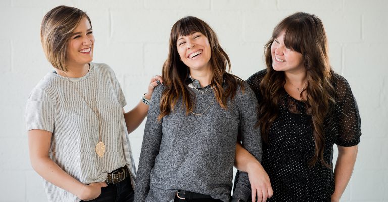 three women happy and smiling together