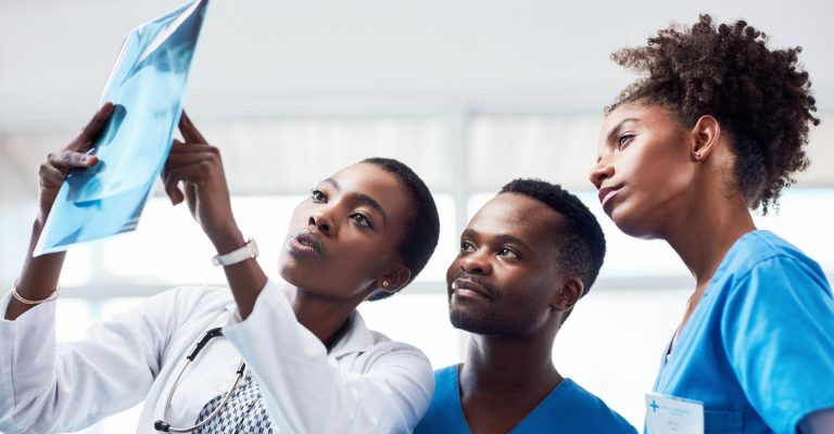 Three people looking at an x-ray.