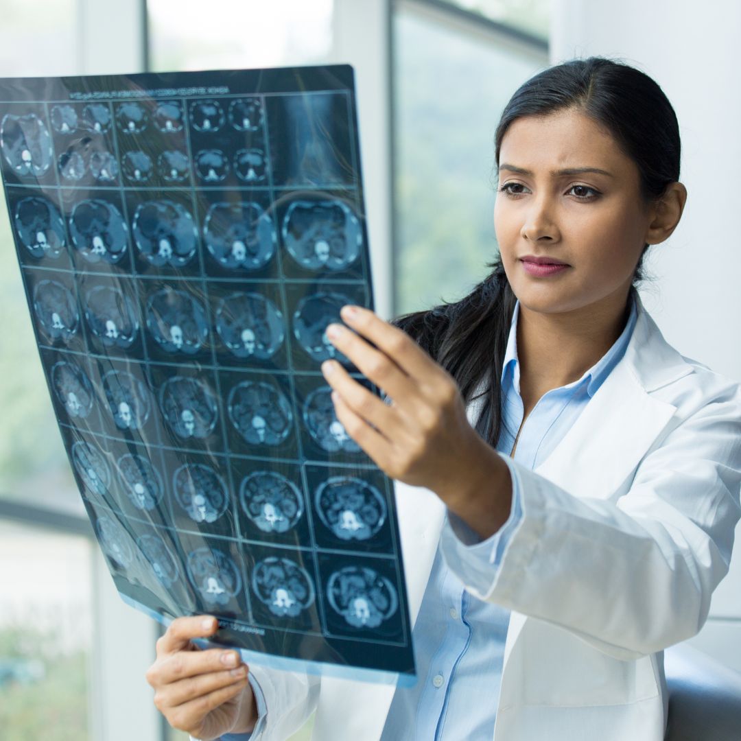 A female radiologist looking at x-rays.